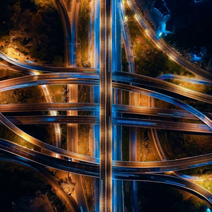 Blick von oben auf ein Autobahnkreuz bei Nacht | TÜVIT