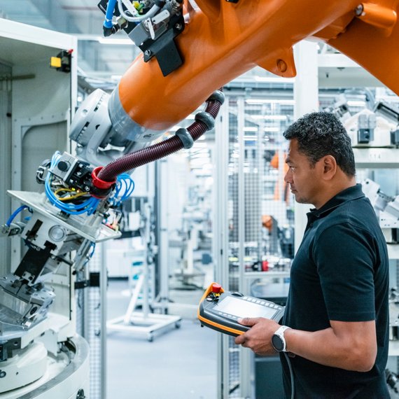A man works on an industrial device.
